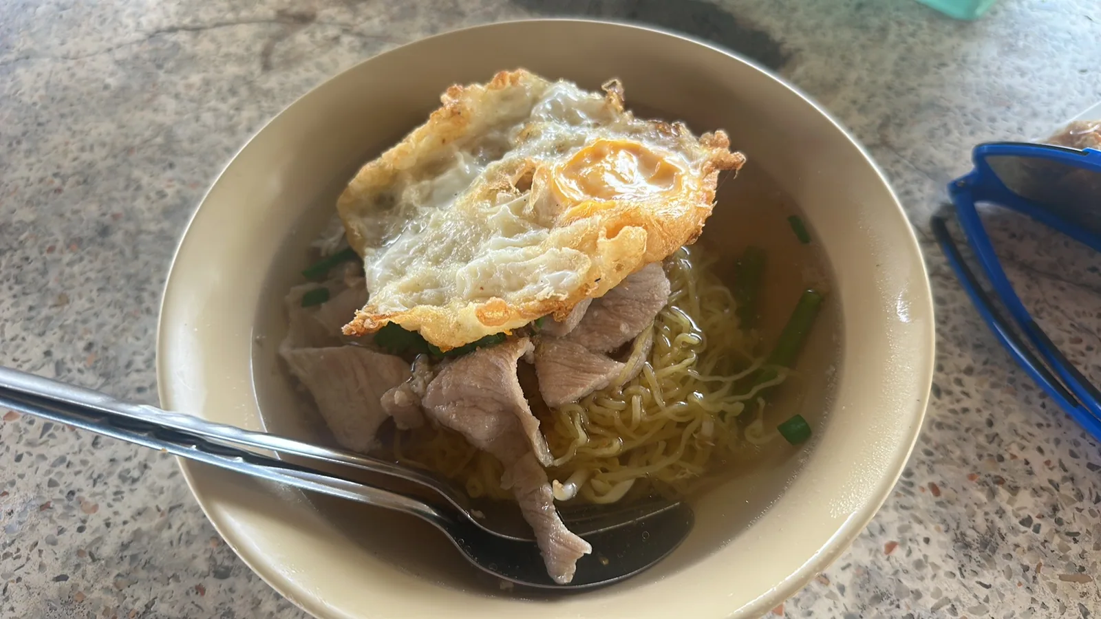 Noodle soup with a fried egg from a local stall